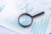 Report with magnifying glass